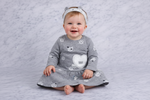 Gray dress with animal prints and a matching headband on a textured gray background